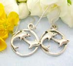 Sterling silver earrings with twin dolpins jumping through the rounded circle pattern