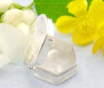 Pyramid shape sterling silver pill box with flower decor on the cover