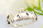 Sterling silver ring with two hand holding a heart and celtic knot work decor each side
